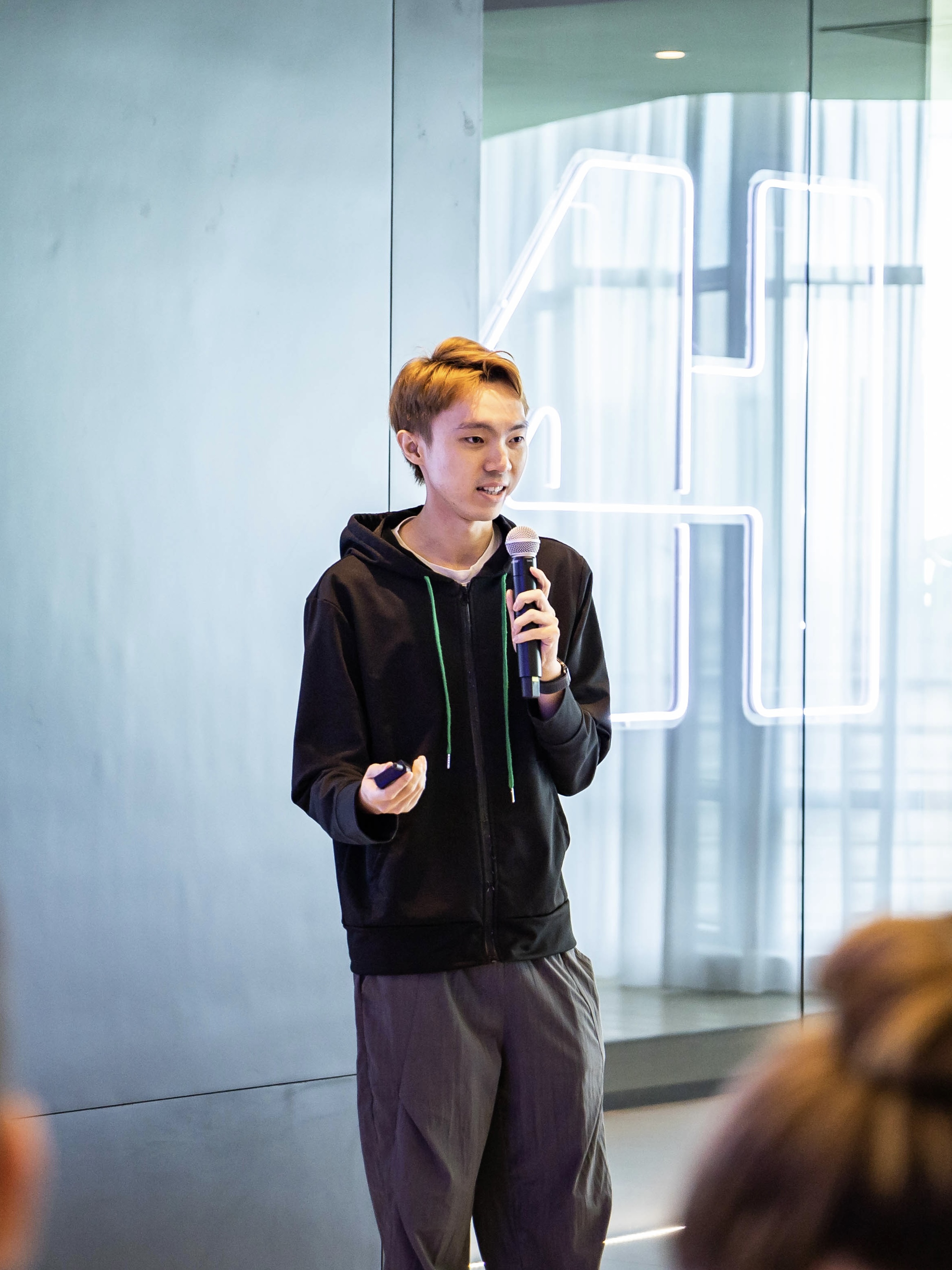 Edmund Hong speaking into a microphone